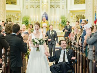 Couple recessing down aisle at Christian wedding ceremony in church