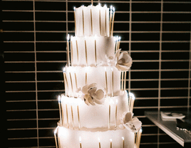 Unique white wedding cake with candles