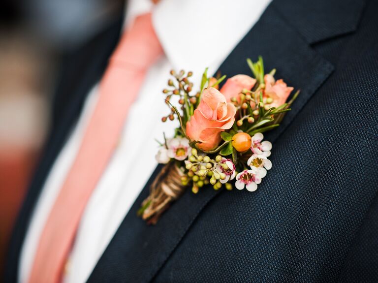 Groom wearing a peach colored boutonnière. 