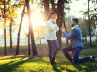 Man proposing to woman in middle of field