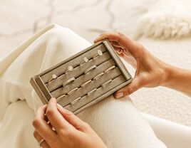 Bride holding jewelry box with engagement rings inside