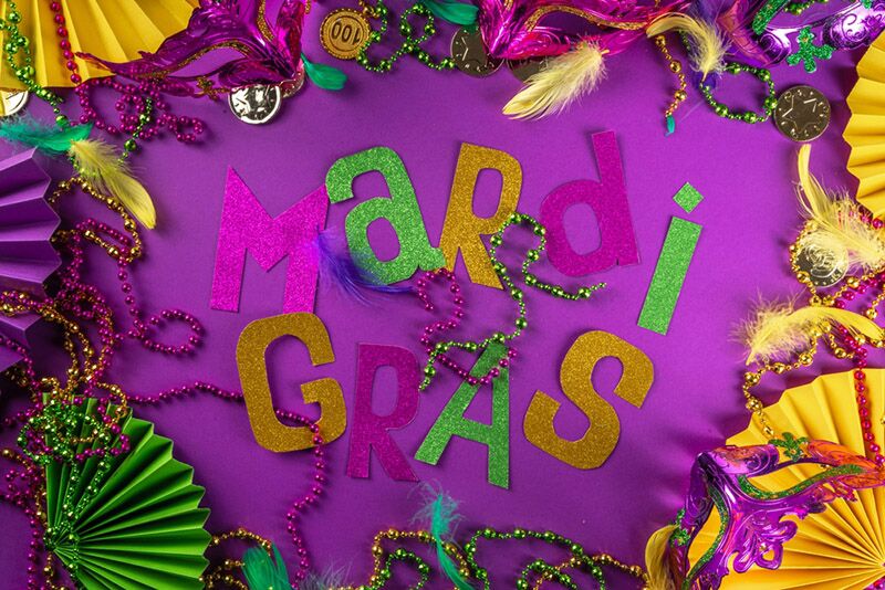 Purple, green, and gold Mardi Gras party decorations