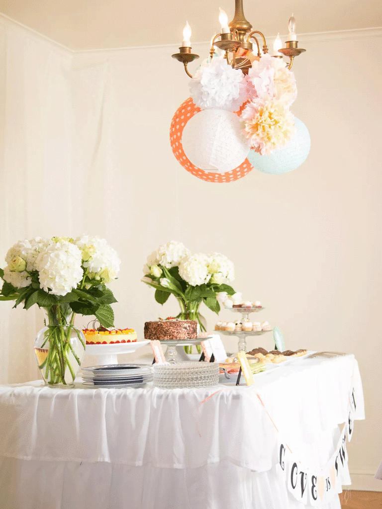 A dessert table at a bridal shower with colorful paper lanterns. 