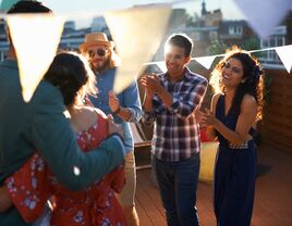 Group of friends celebrating couple who recently got engaged