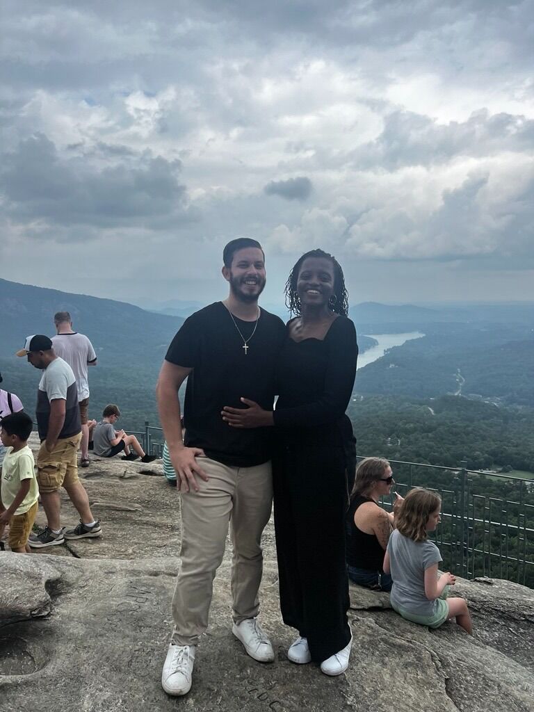Danny drags June up to the top of Chimney Rock, NC