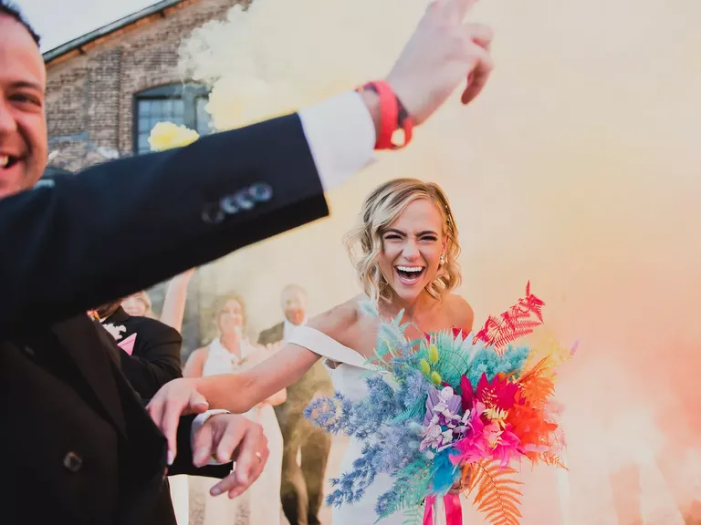 Bride With Neon Bouquet of Dyed Flowers, Feathers Smiling Through Color Smoke