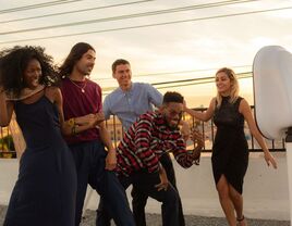 Guests dancing on the rooftop patio in front of a photo booth