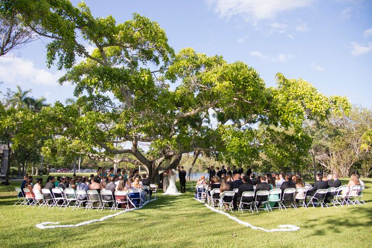 Tree Lined Park Ceremony With White Accents