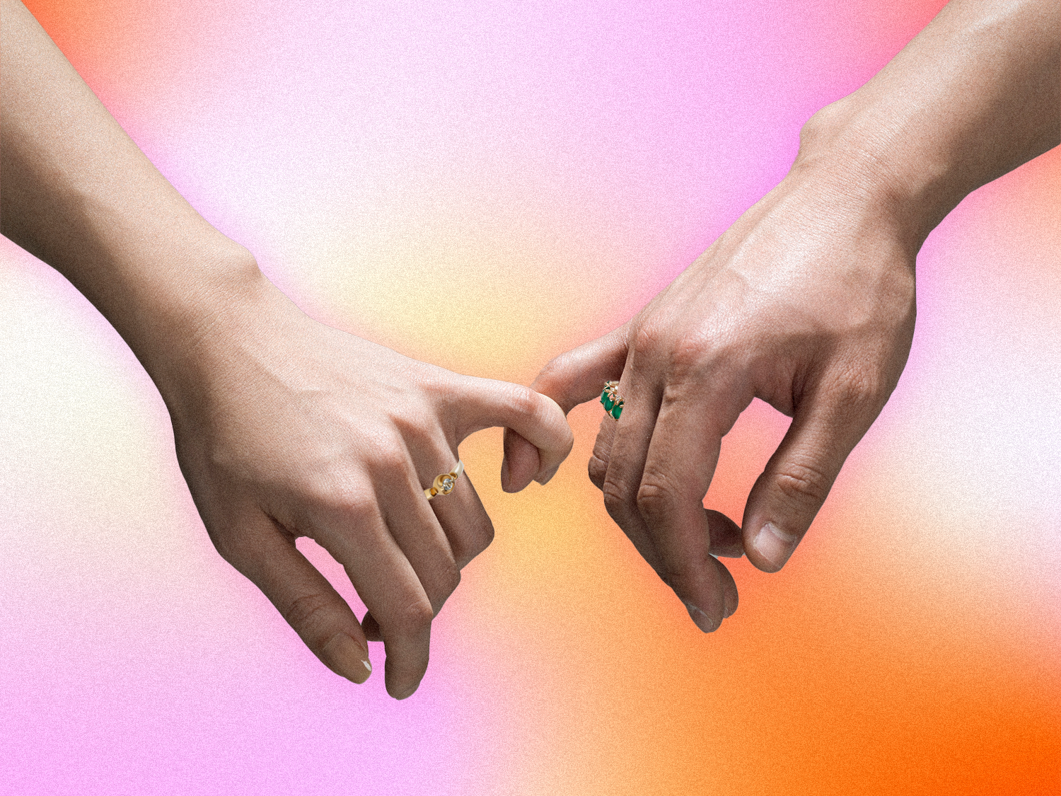Couple holding pinky fingers wearing promise rings