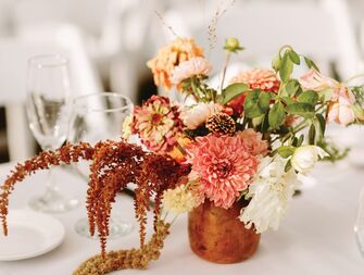 elegant fall wedding centerpiece with orange, blush and coral flowers