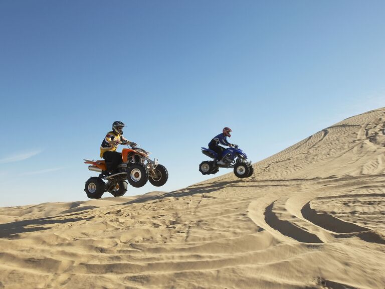 Guys on ATVs in the desert
