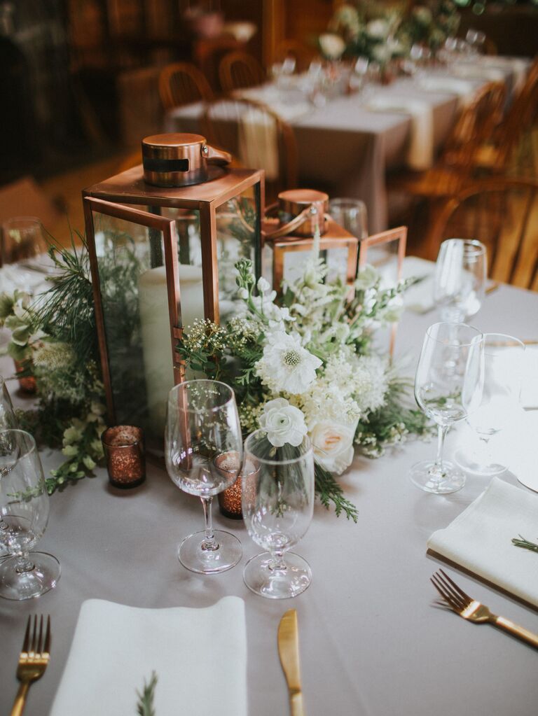 classic rustic small wedding centerpiece with brass hurricane lanterns and white flowers
