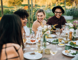 Friends eating at table at bachelorette party brunch