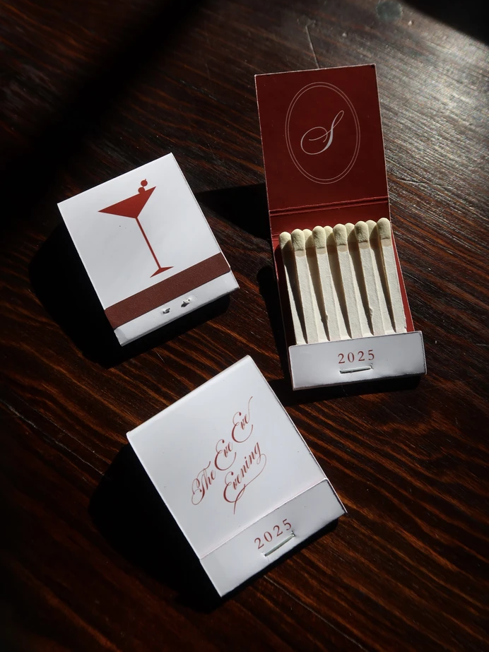Custom red and white matchbooks with a martini glass on one side and a couple's monogram and wedding year on the other