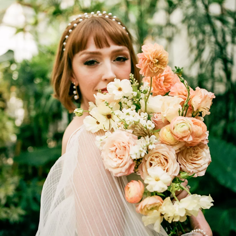 A cascading wedding bouquet in peachy tones 