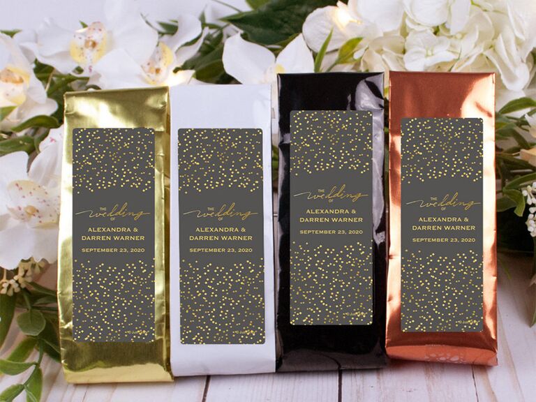 Custom coffee bags with dark label featuring gold flecks and couple's names