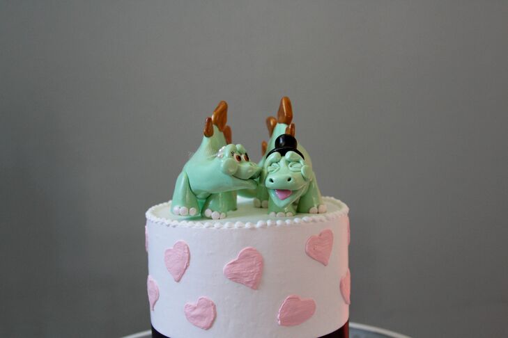 Kissing dinosaur wedding cake topper