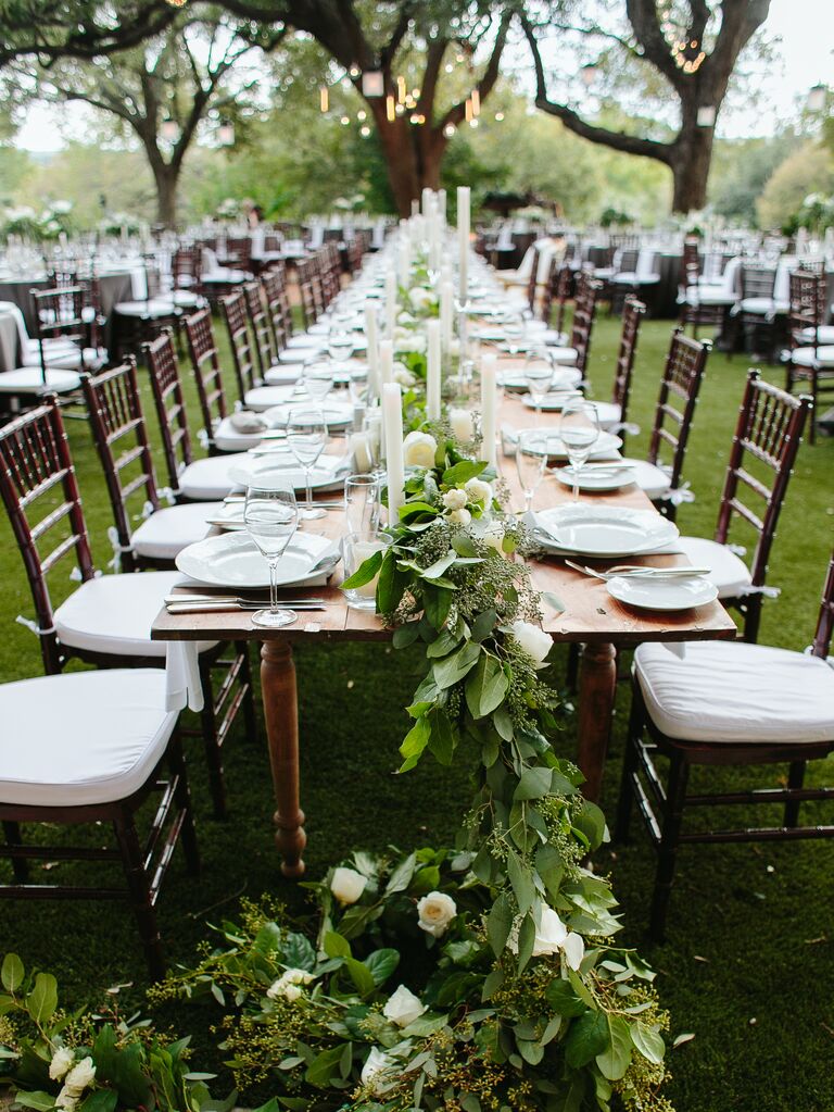 Tall candlesticks with low white hydrangea centerpieces
