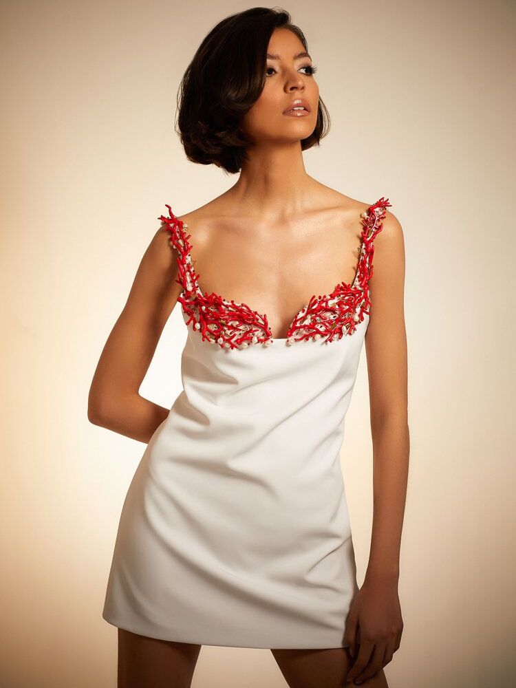 White mini dress with coral-inspired detailing. 