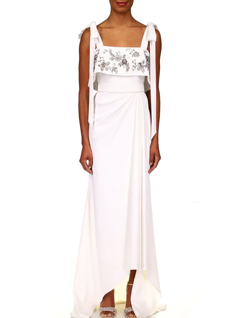 Tie bow shoulders and embellished flowers on bodice with subtle high-low skirt