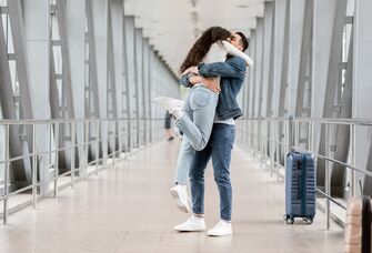 Couple hugging airport long distance relationship 