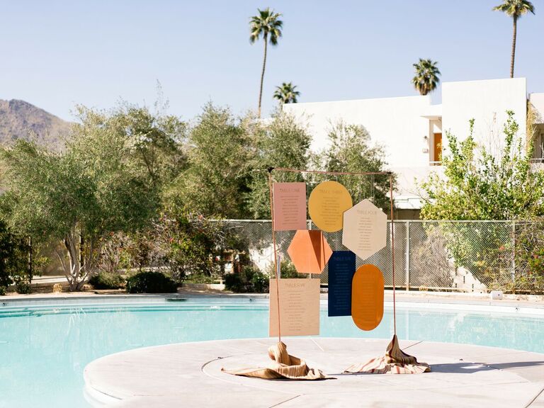 Colorful geometric seating chart at poolside Palm Springs wedding