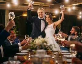 Guests raising a toast to the newlywed couple