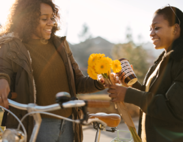 Couple exchanging flowers and coffee on Valentine's Day