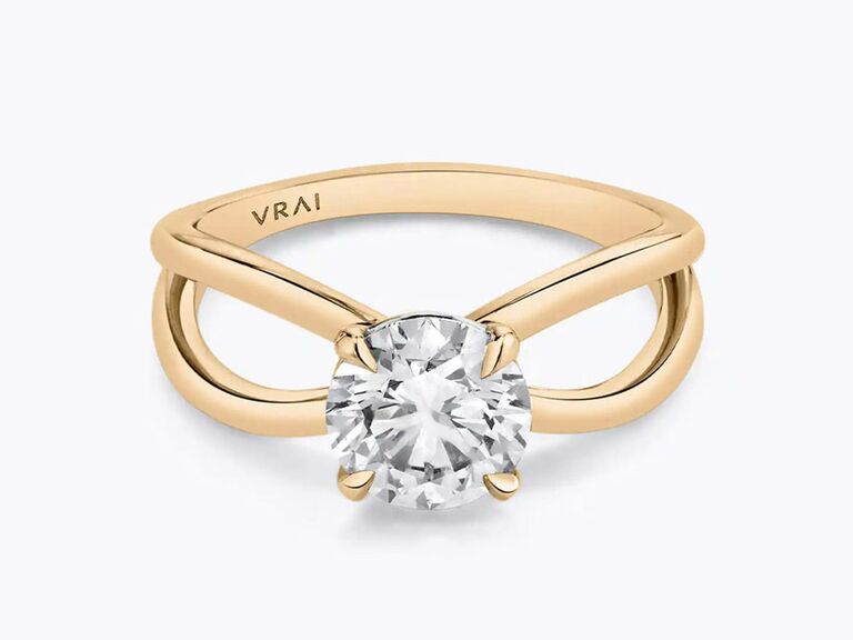vrai split shank engagement ring with round diamond center stone yellow gold claw prongs and plain yellow gold split shank band