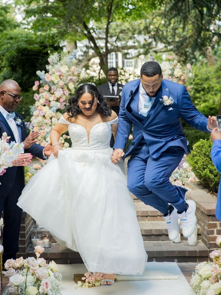 couple jumping the broom