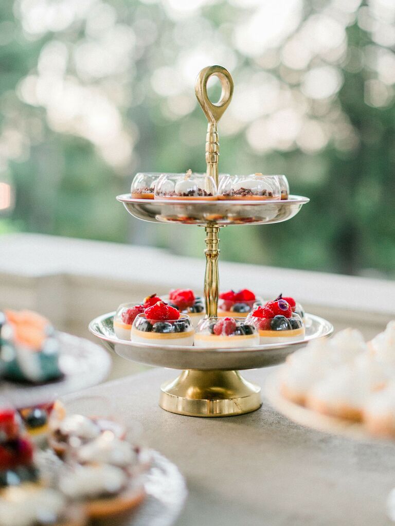 Display of fruit tart desserts at summer wedding reception