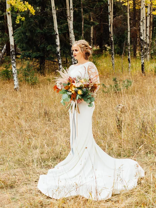 A bride poses for a photoshoot in a dress from Brilliant Bridal Denver