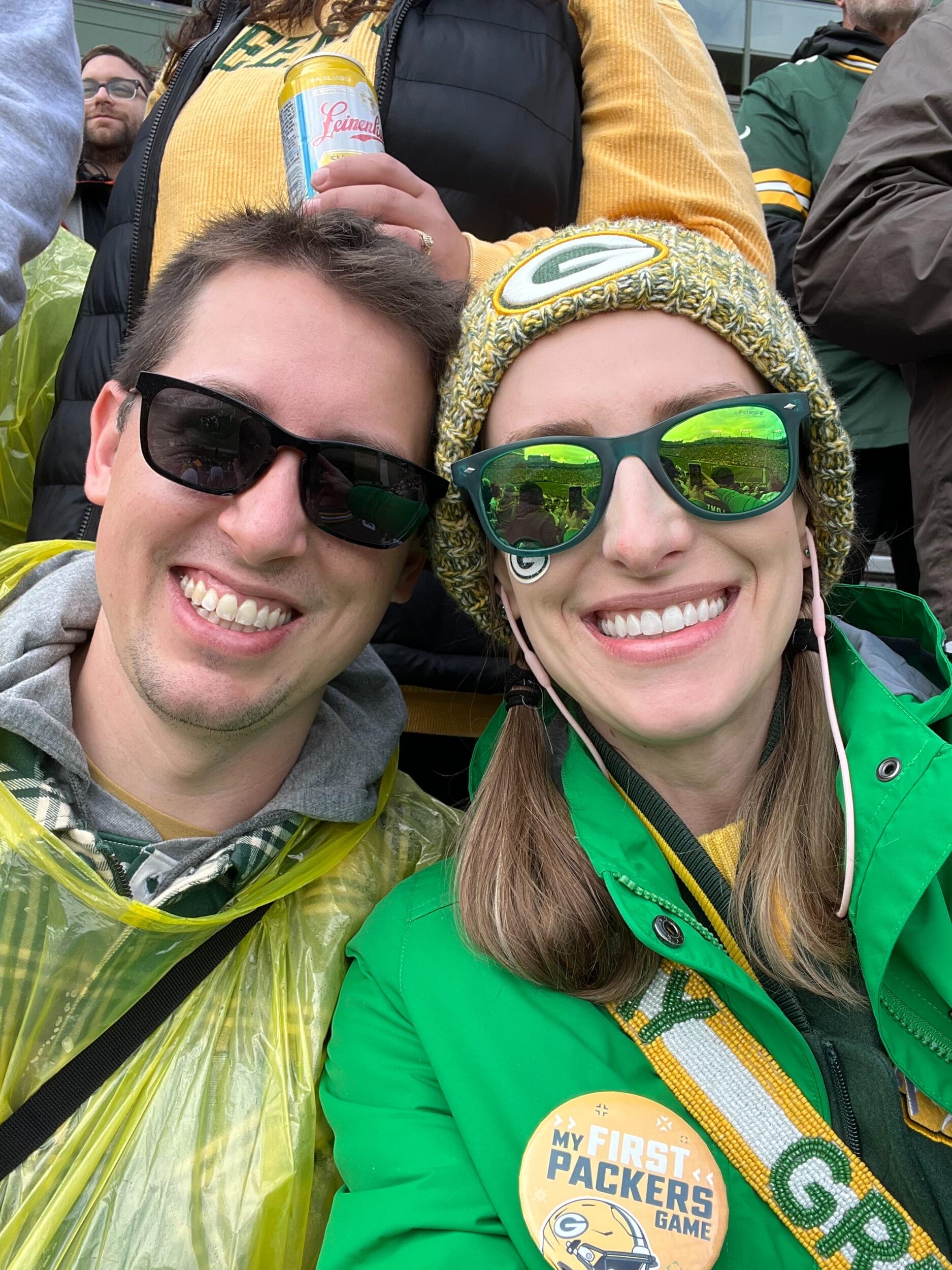 Tyler takes Kirsten to her first Packers game, courtesy of Tyler's dad's season tickets that were willed to him by his father (Tyler's grandfather). It is very chilly and rains nearly the whole game, but Kirsten's ear plugs are effective at dampening sound and she gets a cool pin for it being her first Packers game! She hopes for a warmer and drier day for her next game attendance.