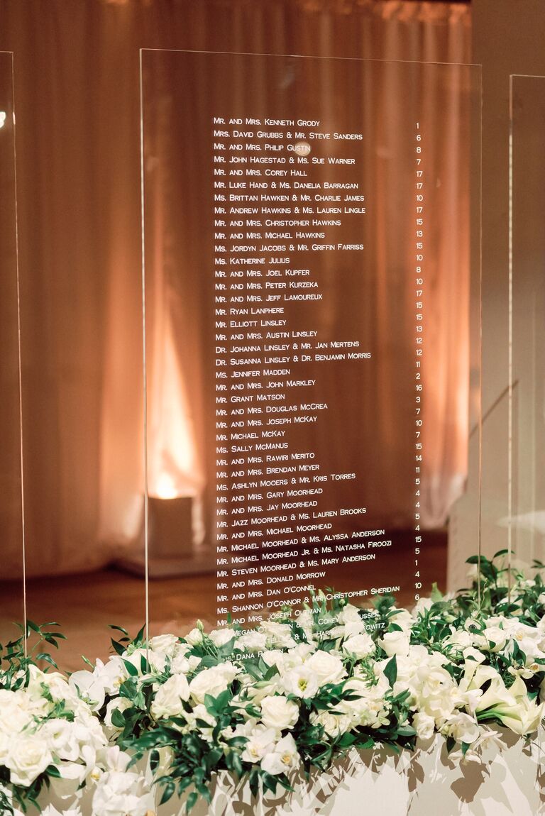 Modern acrylic seating chart with white flower accents