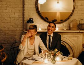 Couple laughing during wedding speeches.