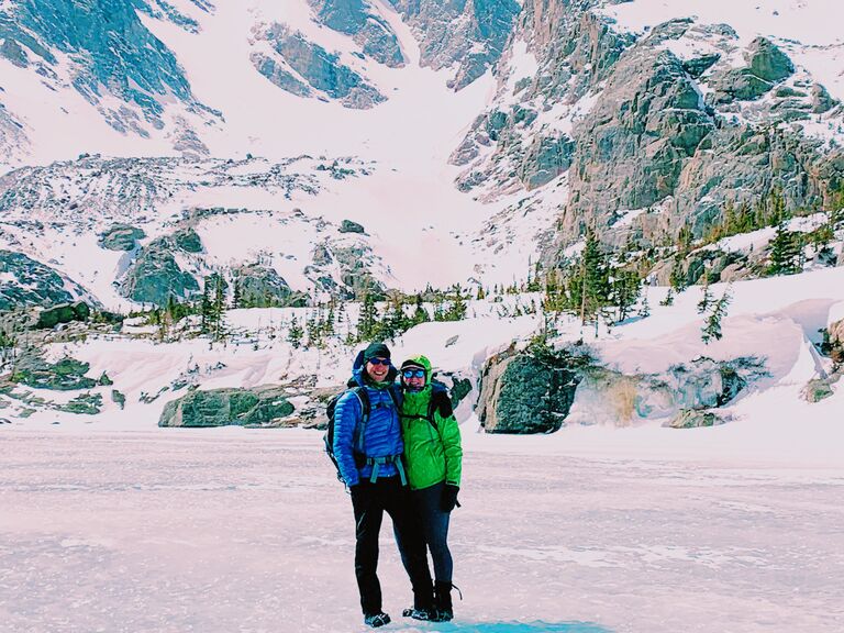 Ivy and Brian in Rocky Mountain National Park standing on Sky Pond!