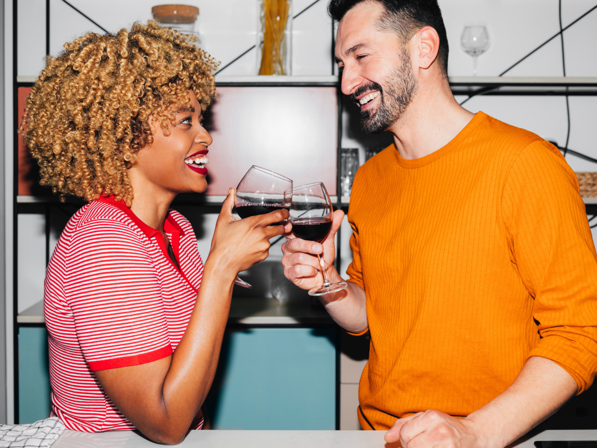 Couple enjoying cooking date with wine, dating in your 30s