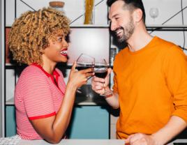 Couple enjoying cooking date with wine, dating in your 30s