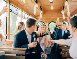 Bride and groom and wedding party drinking champagne on Cape Destinations trolley in Cape Cod