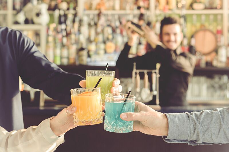 Bartender with colorful drinks