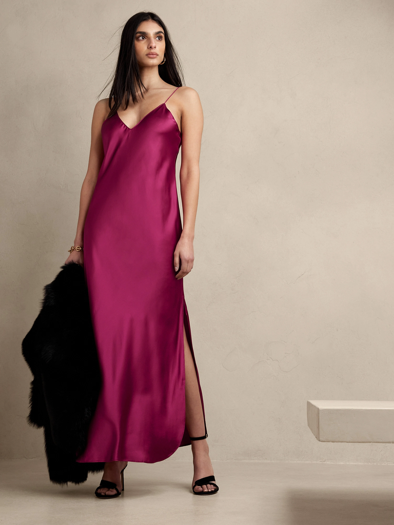 A model wears this maroon slip dress with spaghetti straps.