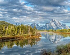 The mountain rise over the river at Jackson Hole, Wyoming.