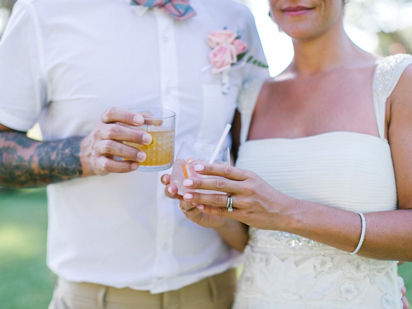Bride and groom holding cocktails