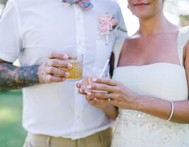 Bride and groom holding cocktails