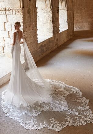 Wedding dress made of bi-elastic crepe. Lace bodice with deep neckline, straps, open back, and lace train. Includes cape.
