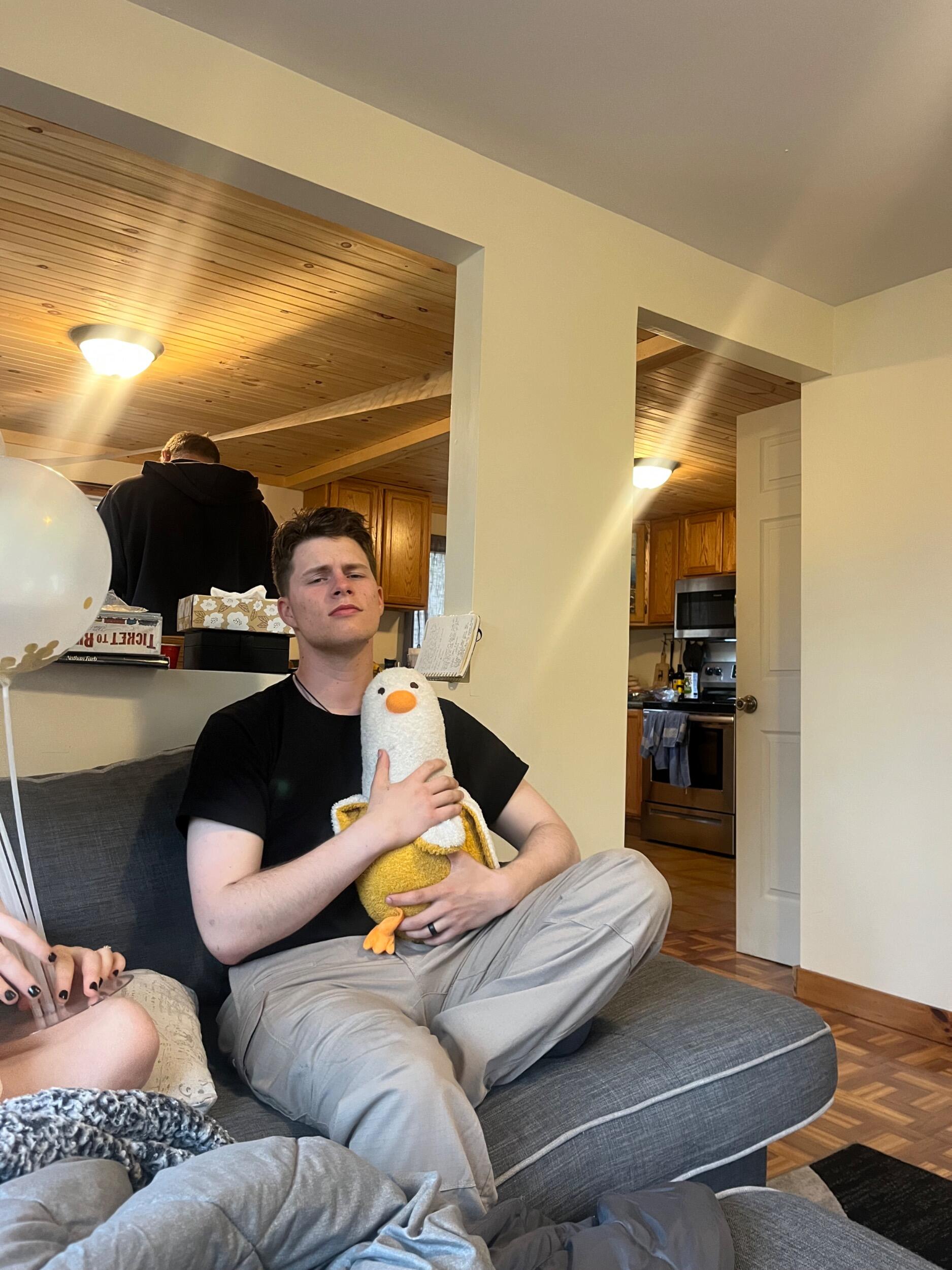 Gavin with Banana Duck- (a stuffy with a long list of inside jokes behind him) 