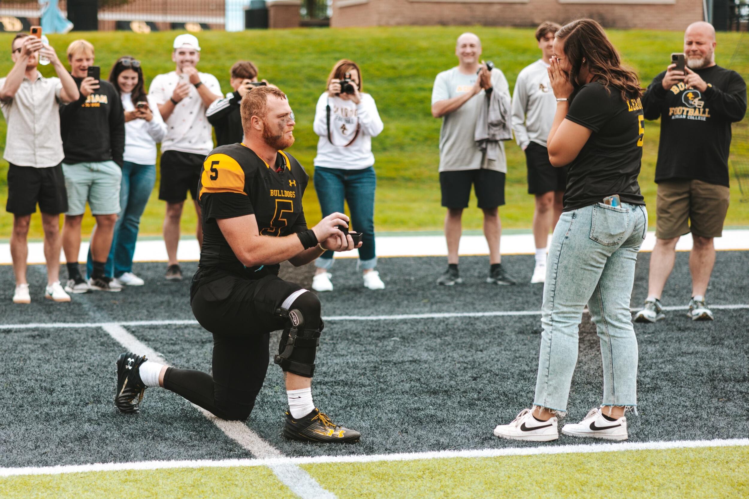 Tche proposing to Lauren after one of his football games