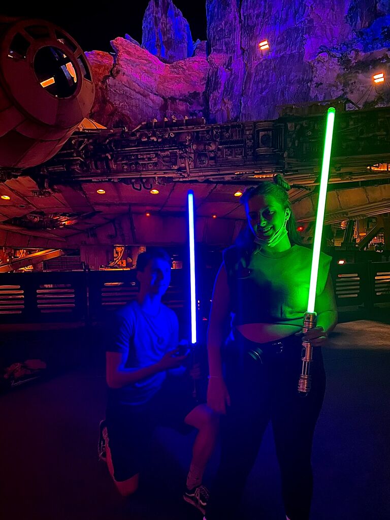 Ethan proposed in front of the Millenium Falcon as the park was closing.