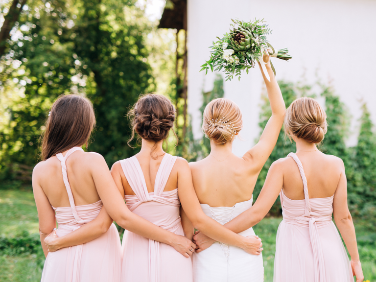 Bride and bridesmaids in open back dresses