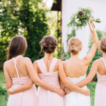 Bride and bridesmaids in open back dresses